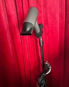 “Blow dryer mounted on tripod holder used for controlled paddle brush blow-drying.”