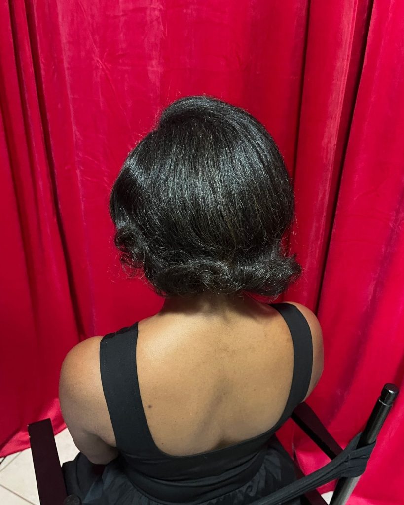 Finished vintage silk press hairstyle with structured curls created through a traditional setting technique.
