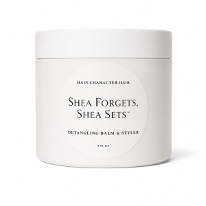 Shea Forgets, Shea Sets Detangling Balm and Styling Preparation by Hair for Heirs in a white cosmetic jar.